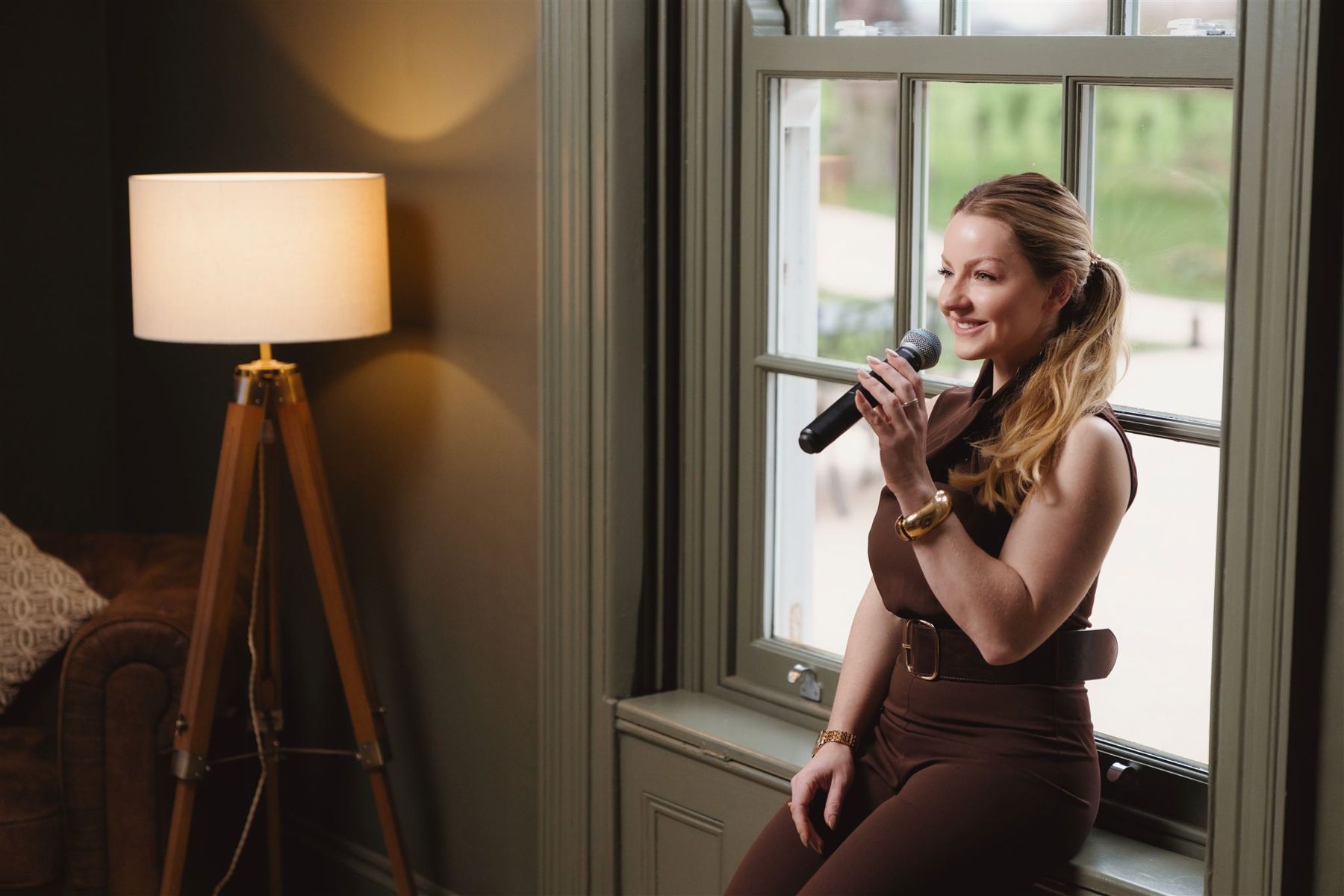 Abigail singing by a window at a wedding venue
