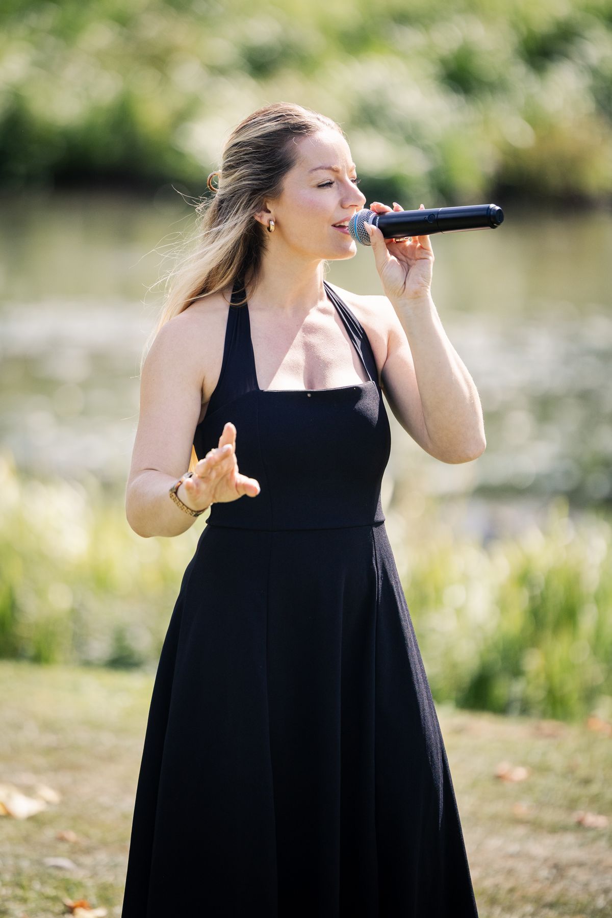 Abigail singing outdoors by the water